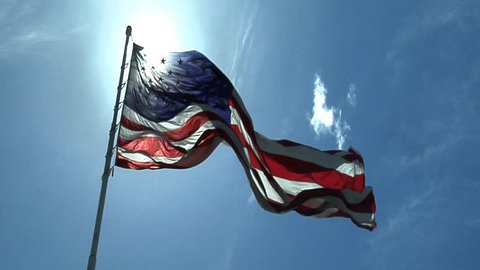 HD clip of the American flag against a beautiful blue sky.