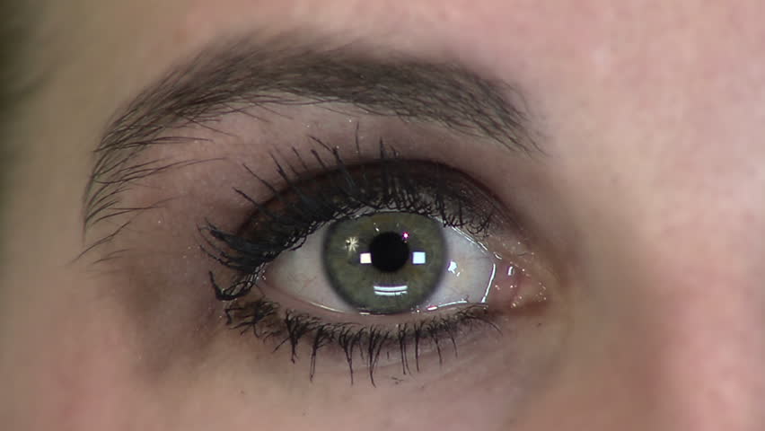 Close up HD clip of a beautiful green eye looking around.
