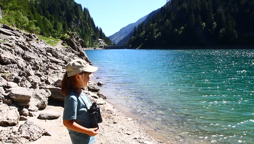 small hiker looks the view with binoculars