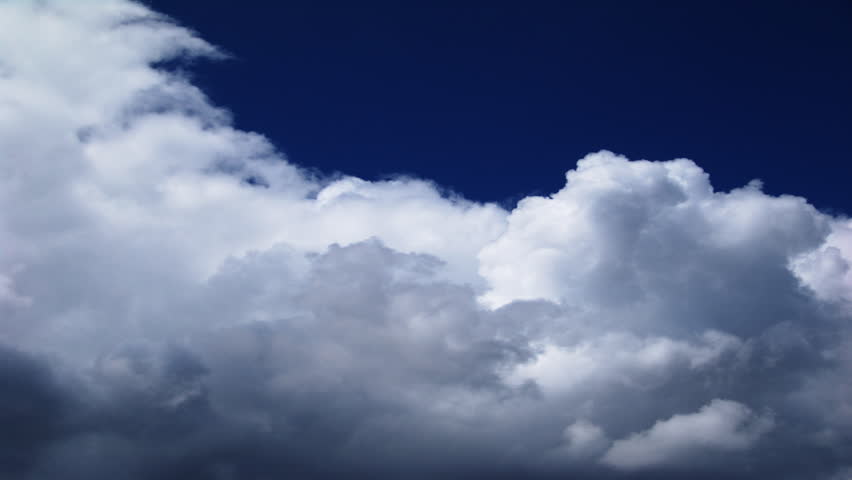 An HD time lapse of clouds against a dark blue sky. 