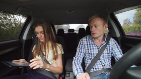 Young couple using tablet computer in a car in 4K - Powered by Shutterstock - Get 15% off with code: PIKWIZARD15