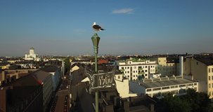 Drone aerial close-up video of Baltic Seagull, vane on old building with Helsinki old town skyline on the background