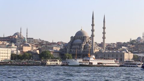 ISTANBUL, TURKEY - JULY 31, 2015 : Eminonu Harbor, Beyoglu district historic architecture and Muslim Mosque medieval landmark over the Golden Horn bay in Istanbul, Turkey