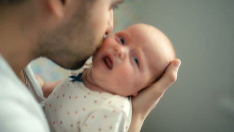 Father holding newborn baby girl