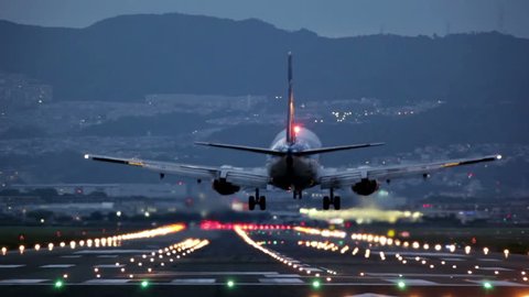 big airplane landing at Osaka-Itami International Airport during the blue hour, Japan