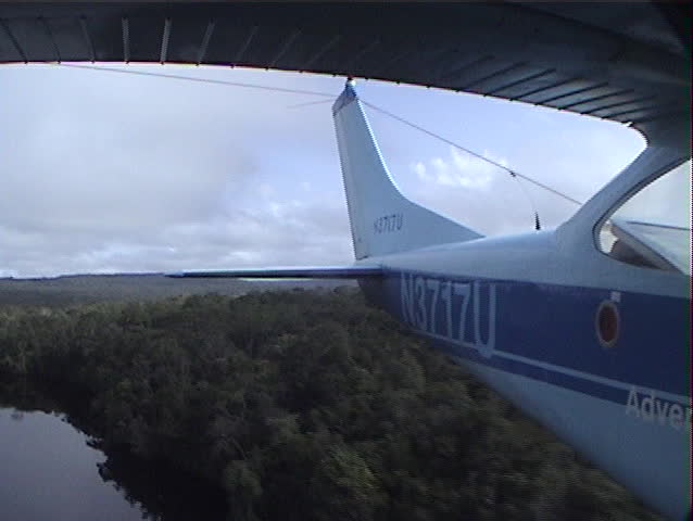 Beautiful rear facing aerial shot from a plane flying over a river