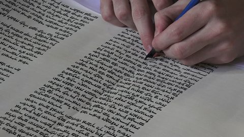 AUCKLAND -  AUG 21 2016:A sofer setam finishing the final letters of a sefer Torah. In the Torah's 613 commandments, the second to last is that every Jew should write a Sefer Torah in their lifetime.