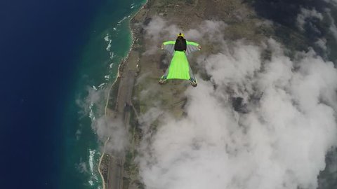 Lifestream men jumping with a wingsuit parachute over Hawaii, slow motion