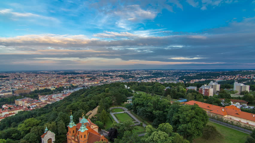 Wonderful timelapse View To The City Of Prague From Petrin Observation Tower In Czech Republic. Blue cloudy sky before sunset