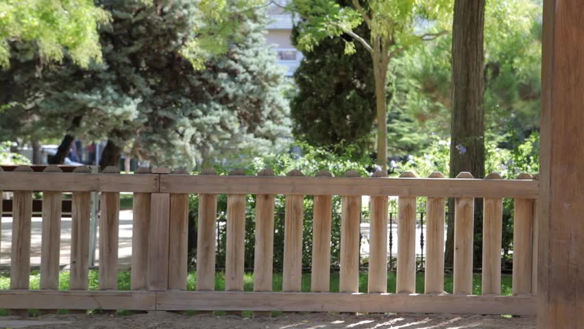 Young girl child playing in playground in sunny green park, running and turning making shapes and waving colorful ribbon on holiday, outdoors lifestyle. Kid having fun smiling with joyful expression.