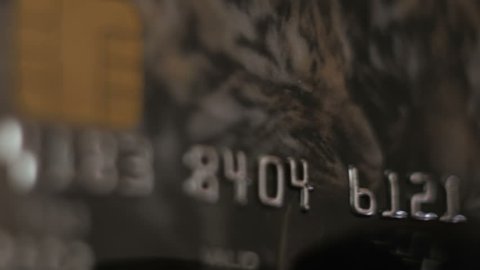 Credit Card swipe through PIN Terminal. Extreme closeup. Shallow depth of field