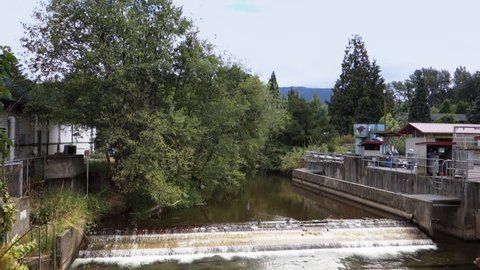 A daytime establishing shot of a dam near the fish hatchery in Issaquah, Washington.  	