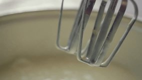Close-up of slow motion mixing muffin mixture with electric mixer FullHD 1080p