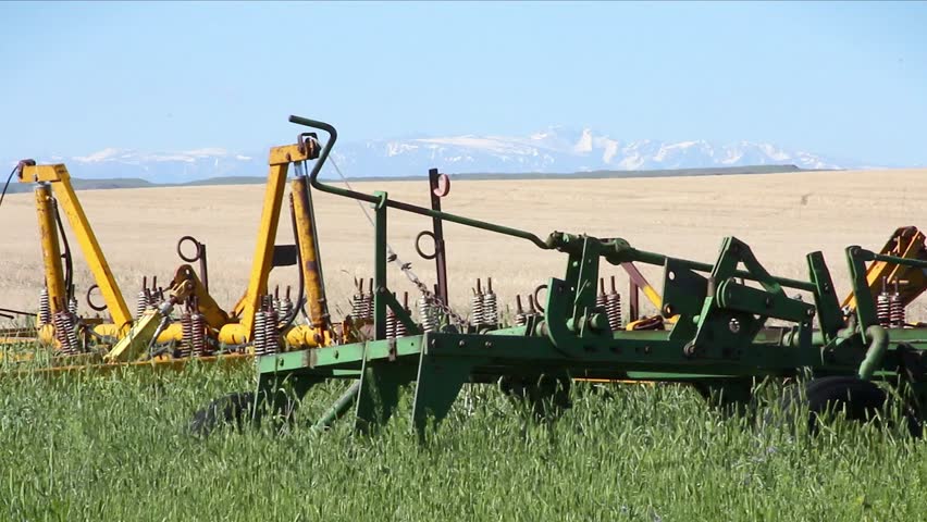 Rusty farm equipment rests in a field

