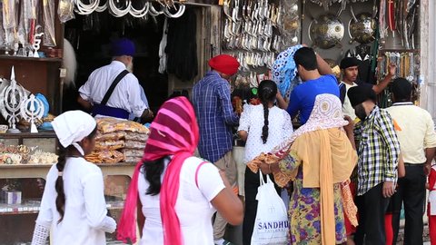 AMRITSAR, INDIA - SEPTEMBER 28, 2014: Unidentified Sikhs and indian people in the gift shop next to the Golden Temple in Amritsar. Sikh pilgrims travel from all over India to pray at this holy site.