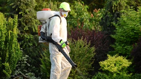 Pest Control. Caucasian Gardener with Pest Control Sprayer Equipment