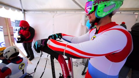 MOSCOW, RUSSIA - JANUARY 23, 2016: Sportsmen are ready for the competition, sitting on sledge and repeating movements. Luge World cup at Sparrow Hills (Vorobyovy Gory)