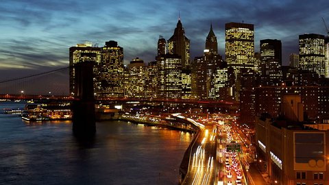 Busy traffic in New York City Manhattan with Brooklyn Bridge at dusk time lapse