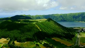 4k time lapse landscape video of lake of fire Lagoa da Fogo in Sao Miguel island Azores Portugal with clouds on blue sky moving fast projecting shadows on lagoon view in timelapse travel destination
