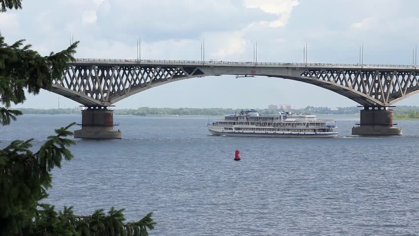 The ship sails under the bridge Saratov-Engels, Volga river, Russia
