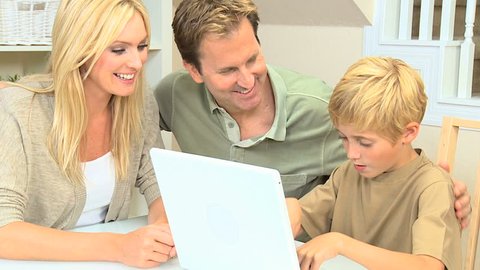 Young Parents Watching Son Use Laptop Stock Footage Video (100% Royalty