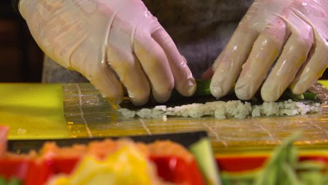 Chef prepares vegetarian sushi roll