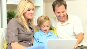 Young caucasian family having fun on a laptop computer