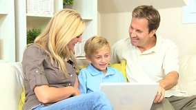 Young family talking to family via video web chat on a laptop