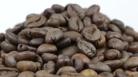 Close up of coffee beans. Loop rotation. Front of the camera rotates plate with coffee beans