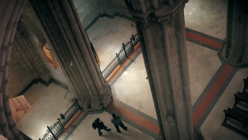 People walking on the nave of the cathedral of Manizales view from the balcony when the lights enters from the stained glass. 4k