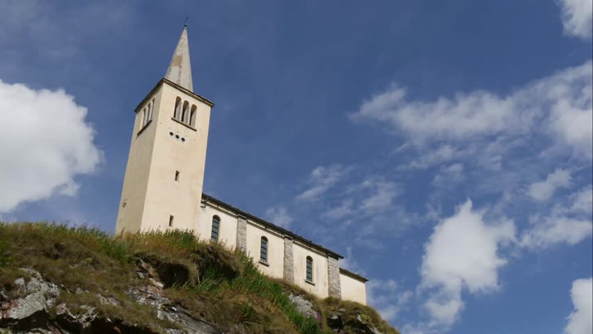 time lapse:  clouds and a small church in a mountain village of Piedmont, Italy.