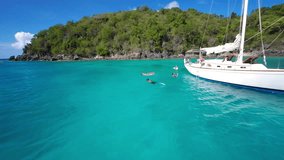 Slow motion video of a group of people relaxing on a Sailboat in Hawksnest Bay, St John, United States Virgin Islands