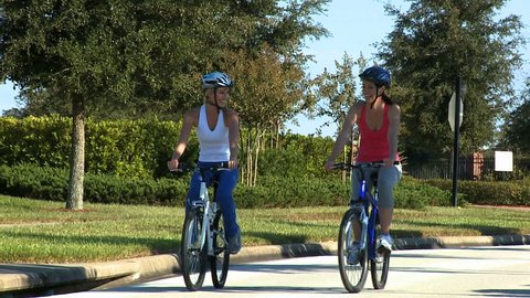 Young females staying fit and healthy out cycling together on suburban roads