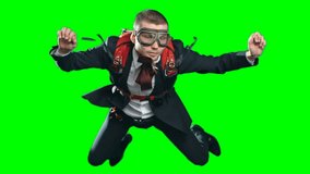 Slow motion footage of business man wearing parachute, formal suit and aviator mask, flying in mid air experiencing free fall looking calm and confident, chroma key against green screen background
