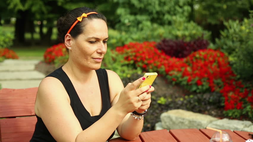 Woman is smilling and typing sms
