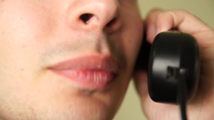 Mouth of man talking on the phone.