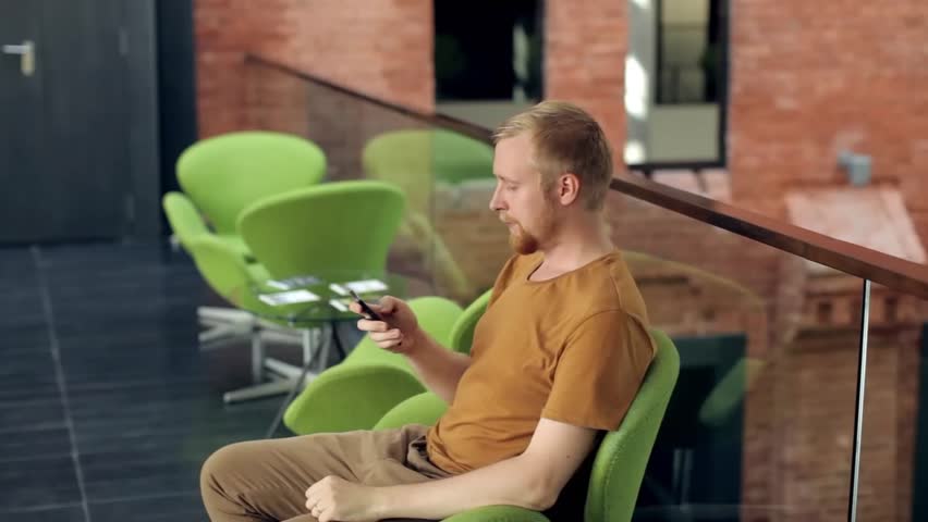 Man With a Phone is in the Lobby Business Center
