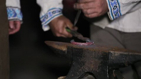 blacksmith makes a horseshoe