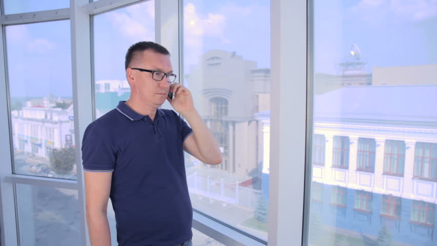 Young man with money us dollars having a businesscall and looking unhappy.