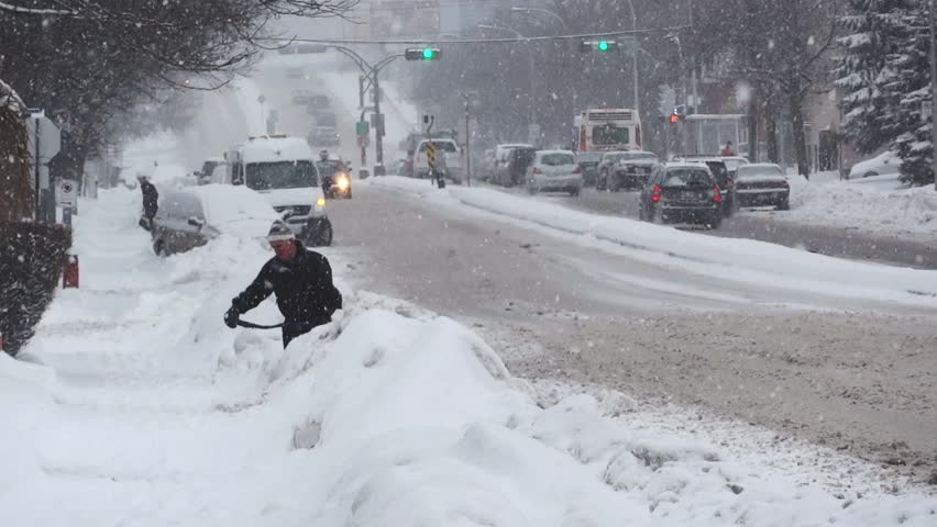 MONTREAL, CANADA - CIRCA JANUARY 2011: Man shovels snow during a typical North