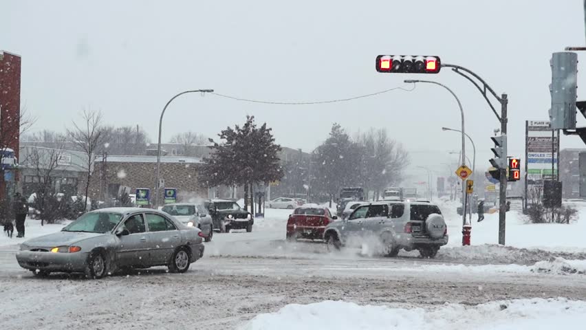 City intersection during snowstorm.