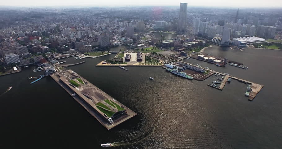 Osanbashi Pier and harbor ferries below the Yokohama waterfront skyline.