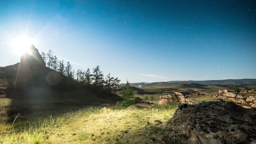 Moonset above camping at night in the mountains. 4K time lapse