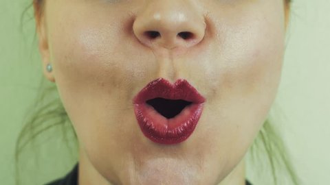 View of woman with red pomade on lips sing in front camera. Mouth. Expression. Teeth. Close up