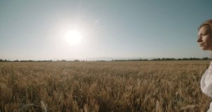 Christianity Concept Young Pretty Woman Raising Hands in wheat field ,sunset,slow motion