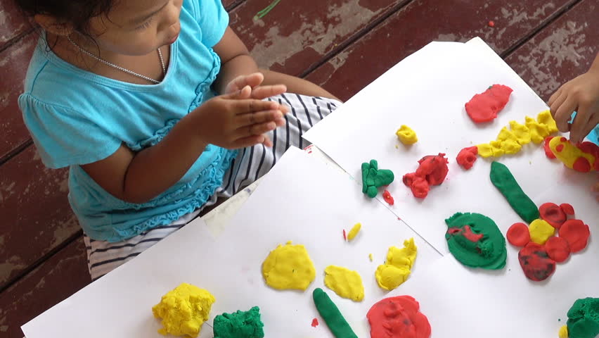 Fun little girl with play dough modelling clay for kids