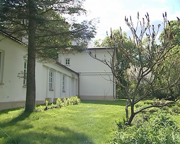 Old architecture house and beautiful garden in yard in spring. 