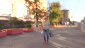 Blurred Moscow center street view. Unrecognizable people, cafe and shopping center, wide shot. 4K background bokeh video