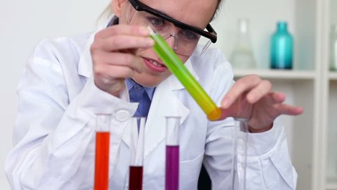 Female scientist mixing chemicals in test tube