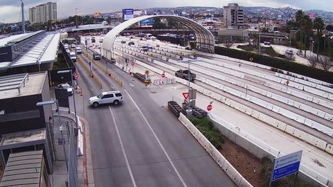 SAN YSIDRO, CALIFORNIA/USA: March 2016- A time lapse shot of cars entering and leaving Mexico at the border crossing. A high angle view looking down on the highway at vehicles coming into the USA.